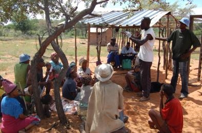 A Community Health Worker instructing the San at the Voormansput settlement on the use of condoms.