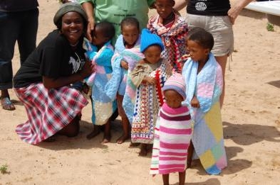 The San children with their blankets which will be useful during the cold winter nights.